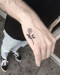 a person with a rose tattoo on their left hand