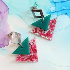 Handmade emerald green and pink foil flakes triangle resin earrings The stud part is made of stainless steel On the measurement earrings display photo: on the left are cm and on the right are inches Gifting and packaging: Each item comes carefully wrapped in tissue paper and comes in a small cardboard box to fit through the letter box. Earrings also come on branded carding I can also add a handwritten note if the item is purchased as a gift for a more personal touch. Gift wrap for special occasions is also available upon request. Should you require your order before the estimated delivery date (for a gift for example) please don't hesitate to contact me, I am always happy to help! Materials: Each item is made of resin which is very lightweight and comfortable to wear. The earrings posts ar Pink Triangular Jewelry For Gifts, Pink Triangle Jewelry For Gift, Pink Triangle Jewelry For Gifts, Emerald Green And Pink, Touch Gift, Earrings Display, Pink Foil, Earring Display, Letter Box