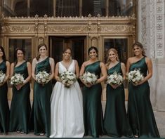 a group of women standing next to each other in front of a building