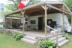 a small white house with a porch and covered patio