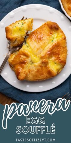 an egg souffle on a white plate with a fork and blue napkin next to it