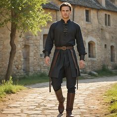 Introducing our sleek Black Medieval Shirt for those in love with historical regalia and superior craftsmanship. This classic design shirt has a loose fit, high collar, and buttoned front to complement Renaissance fairs, historical reenactments, or any other special events looking for a touch of unique taste in attire. With passion, every T-shirt is manufactured under the watchful eyes of skilled workers to ensure we deliver only quality products to our buyers. The soft, long-lasting material an French 1700s Fashion Men, Medieval Mens Fashion, Modern Medieval Fashion Men, Fantasy Medieval Clothes Male, Peasant Clothes Male, Male Witch Aesthetic Fashion, Midevil Outfits Man, Medieval Fashion Men, Medieval Outfits Men