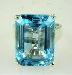 ALL OUR JEWELRY IS MADE IN THE U.S.A. Clear, blue skies on the sunniest of days THIS is the blue of this wonderful Blue Topaz, set in a wide band solitaire design. this a large Topaz but not too large, this ring is for the PRINCESS in you... or your daughter, or your wife, or mom. Whomever is the lucky girl, she will LOVE, LOVE, LOVE this ring, and so will everyone who sees her wearing it! Setting is made of solid .925 sterling silver. BEAUTIFUL Blue Topaz, (1) 16X12 Emerald cut, 13.50 Carats Emerald Cut Solitaire Ring, Topaz Birthstone, Blue Topaz Engagement Ring, Blue Topaz Jewelry, Woman Jewelry, High Jewellery, Topaz Engagement Ring, London Blue Topaz Ring, Neck Jewellery