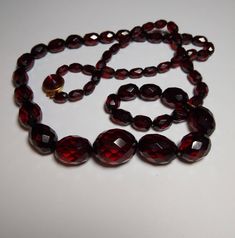 Gorgeous cherry red Bakelite faceted oval beads! All present in correct number and exact graduated order on lovely gold finish chain. New old stock vintage glass and golden brass box clasp.  29" long Perfect example of Mid-Century classic. Wearable piece of jewelry art history. Guaranteed genuine authentic vintage Bakelite phenolic beads. Necklace Fancy, Brass Box, Faceted Bead Necklace, Vintage Cherry, Alexandria Va, Oval Beads, Vintage Bakelite, Box Clasp, Cherry Red