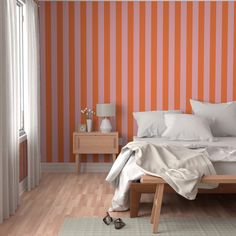 an orange and white striped wall in a bedroom with a bed, nightstands, and window