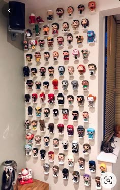 a wall with many head heads on it and a coffee pot next to the window