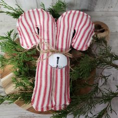 an ornament made out of candy canes on top of a wooden board