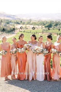 a group of women standing next to each other in front of a field with flowers