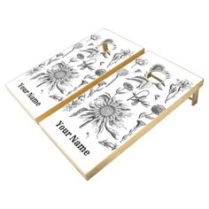 two wooden trays with black and white flowers on them