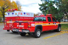 a red fire truck parked in a parking lot