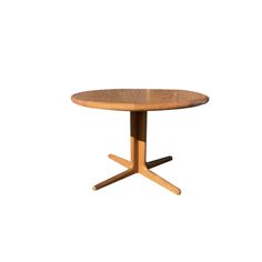 a round wooden table with two crossed legs on an isolated white background for use as a dining room or office space