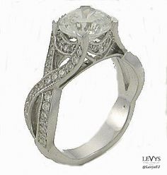 a white gold ring with an intricate design on the band and side stones, set in 18k white gold