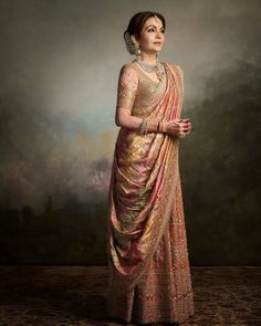 Nita Ambani is simply the queen of fashion. Her impeccable fashion sense never misses a chance to enchant millions of minds. And now, as on July 12, 2024, her doting son, Anant Ambani got married to his long-time girlfriend, Radhika Merchant, it was his doting mommy, Nita's look for each of the events that is worth curating for. Nita is also known for owning some of the prized possessions in her massive collection.    Nita Ambani wore a Surya Shakti necklace with Nizami earrings  ... Dolly Jain, Grooms Mom, Radhika Merchant, Anant Ambani, Mukesh Ambani, Nita Ambani, Brides Mom, Indian Sari