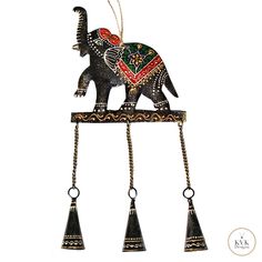 an elephant statue with bells hanging from it's back and on top of a chain