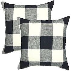 two black and white checkered pillows sitting next to each other