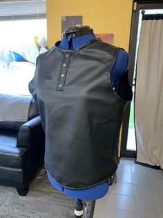 "This is sleeveless leather Henley shirt that we are offering. It is made with a beautiful garment weight leather with a snap front, black brass zipper all the edges are welted. We are offering it with colored welting if desired for a little extra. Please inquire if that is the desired option to make sure we have the color that you want. Small 38\" chest Med 40\" chest Large 42\" chest Xl 44\" chest 2x 46\" chest" Fitted Sleeveless Biker Top, Black Leather Sleeveless Top, Emily May, Mens Tank, Henley Shirt, Friends Show, Black And Brass, Henley Shirts, Mens Tank Tops