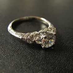 a diamond ring sitting on top of a table