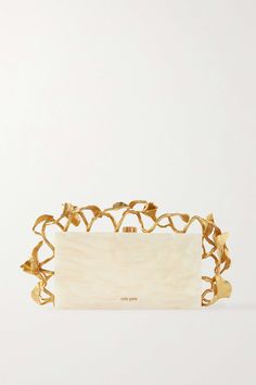 It's the carefully considered details that separate Cult Gaia's bags and make them feel like wearable works of art. This 'Fana' clutch is made from ivory marbled acrylic and framed with gold-tone brass leaves - they're inspired by the lush greenery from the Garden of Eden. The compact interior offers enough space for the essentials. Gold Clutch Bag, Classy Purses, Cult Gaia Bag, The Garden Of Eden, Acrylic Clutch, Gold Clutch, Evening Handbag, Garden Of Eden, The Cult