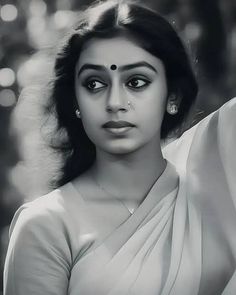 black and white photograph of a woman in sari with her hand on her shoulder