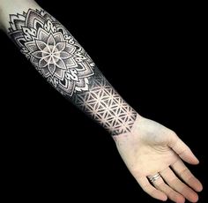 a person's arm with a tattoo on it and an intricate design in the middle