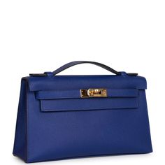 This rare Mini Kelly Pochette is in Bleu Electric epsom leather with gold hardware and has tonal stitching, front flap, two straps with center toggle closure and a top flat handle. The interior is lined with Bleu Electric chevre and has an open wall pocket. Collection: A Origin: France Condition: - Excellent; the bag retains its structure. The leather shows light signs of prior wear. The hardware shows scratching. The inside is clean with light signs wear. Accompanied by: Hermes box, Hermes dust Hermes Pochette Kelly, Hermes Kelly Pochette, Kelly Pochette, Mini Kelly, Open Wall, Hermes Shoes, Hermes Box, Fancy Bags, Fendi Shoes