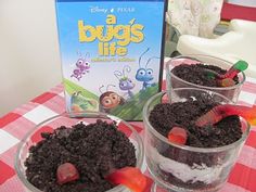 three desserts on a table with a box of bug's life in the background