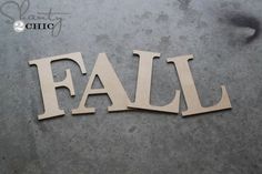 the word fail is cut out from wood and placed on top of a cement floor