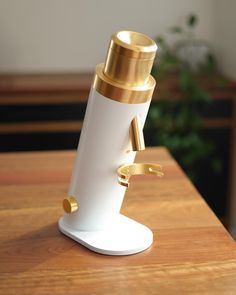 a white and gold object sitting on top of a wooden table