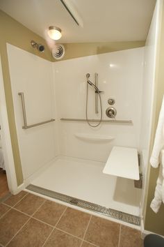 a bathroom with a walk in shower next to a sink