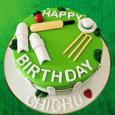 a green birthday cake decorated with cricket equipment