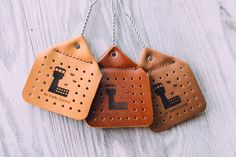 three pieces of leather hanging on a string