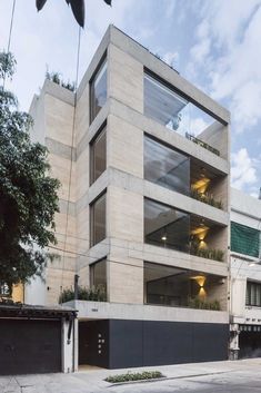 an apartment building with multiple levels and balconies on the second floor is shown