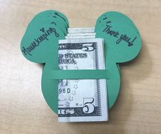 a mickey mouse head made out of dollar bills with the words $ 5 on it