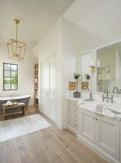 a large bathroom with two sinks and a bathtub in the middle of the room