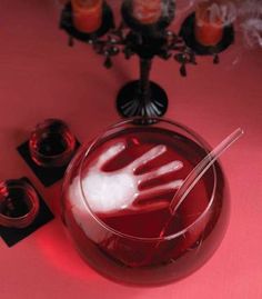 a glass bowl filled with liquid sitting on top of a table