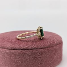 This ring features a beautiful emerald set in a halo ring setting with sparkling natural diamonds all set in 14k solid yellow gold. This design features two tapered baguette diamond accents in the shank. A gorgeous modern look that's perfectly balanced between minimalist and glamour. 14k Gold Emerald-cut Halo Cluster Ring, 14k Gold Emerald-cut Cluster Ring With Halo Design, 14k Gold Emerald Cut Cluster Ring With Halo Design, Gold Emerald-cut Cluster Ring With Halo Design, 14k Gold Emerald Cut Halo Cluster Ring, Gold Emerald-cut Diamond Ring With Halo Design, Gold Emerald Cut Cluster Ring With Halo Design, Gold Emerald-cut Halo Cluster Ring, Gold Emerald Cut Halo Cluster Ring