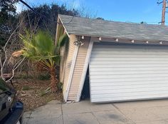 an open garage door on the side of a house