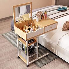 a bedroom with a bed, dresser and mirror on the floor in front of it