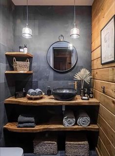 a bathroom with wooden shelves and a round mirror