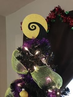 a decorated christmas tree in the shape of a jack - o'- lantern with decorations on top