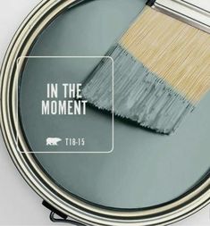 a paint can with the words in the moment on it and an image of a brush