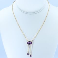 "Vintage Minimalist Lavalier Necklace in 14k Gold with Bezel Set, Oval Cut, Amethysts. This necklace bears a makers hallmark with \"rings and the letter A\", there is also a 14k Purity mark, no origin mark. Necklace measures 15.75\" Total Drop of Lavalier Pendant 1.75\" 1X - 13.6x9.8x5.85 mm Large Amethyst Oval Gem 2X - 7x4.5x3.75 mm Small Amethyst Oval Gems Total weight of necklace 0.179 Oz (78.1 g) This item is vintage. It has been cherished, worn, and preserved by possibly many over the decad Dainty Briolette Necklace For Formal Occasions, Formal Briolette Jewelry With Delicate Chain, Classic Drop Necklace With Delicate Chain For Formal Occasions, Classic Drop Necklace With Delicate Chain For Formal Events, Elegant Lariat Necklace With Cable Chain For Formal Occasions, Elegant Yellow Gold Lariat Necklace With Gemstone, Delicate Oval Pendant Necklace For Formal Occasions, Delicate Pendant Drop Necklace For Formal Occasions, 14k Gold Pendant Drop Necklace For Formal Occasions