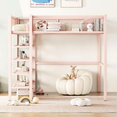 there is a pink shelf with books on it in the room next to a stuffed animal