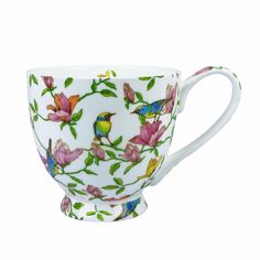 a coffee cup with birds and flowers painted on it