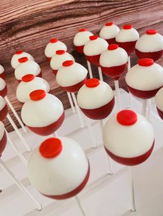 red and white cake pops are arranged on sticks