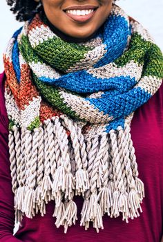 a woman wearing a multicolored knitted scarf