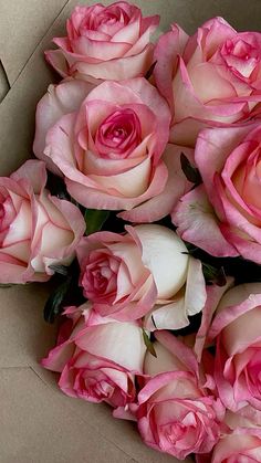 a bunch of pink roses in a box