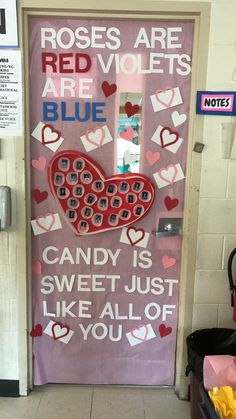 a door decorated with candy hearts and notes on the front doors for valentine's day