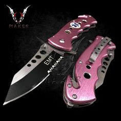 two pink knives with black handles on a black background