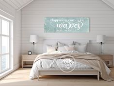 a bedroom with white walls and wood flooring has a large poster above the bed that says happiness comes in waves